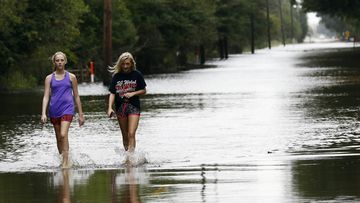 Weakening storm Harvey slogs into Louisiana, more flee Texas