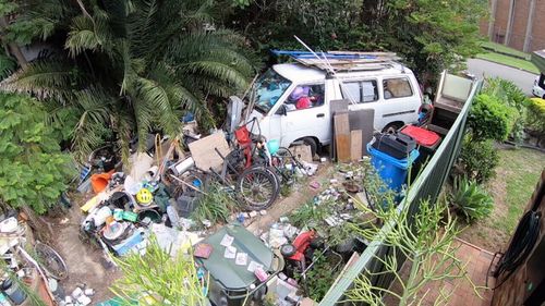 This van in Robert's yard appears to be stuffed full of trash.