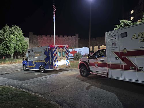 Ambulances are parked outside a hotel that is acting as a reunification center after a shooting at a country club in Nashua, New Hampshire.