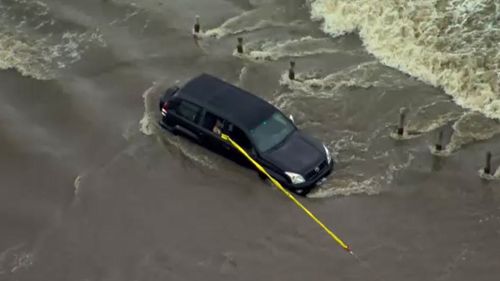 Two people are trapped in a car in floodwaters in Melbourne's south-west.