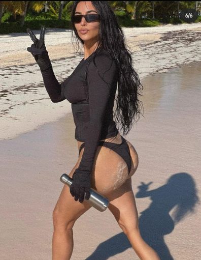 Kim Kardashian deletes bikini photo after fans accuse her of Photoshopping image.