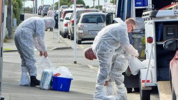 Police crime scene investigators get ready to enter the Timaru property where three children were found dead.