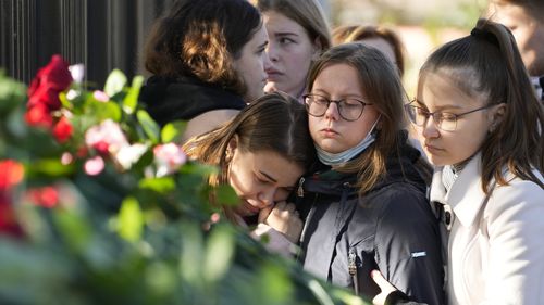 Students comfort each other as they gather outside the Perm State University following the campus shooting. (AP Photo/Dmitri Lovetsky)