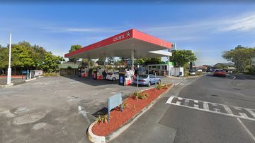 A service station worker was held at knifepoint in QLD