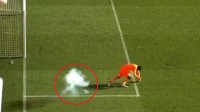 Football game abandoned, goalkeeper stretchered off after firework thrown onto pitch
