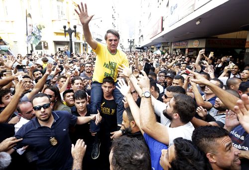 Brazilian presidential candidate Jair Bolsonaro waves to the crowd in Juiz de Fora, 200kms north of Rio.