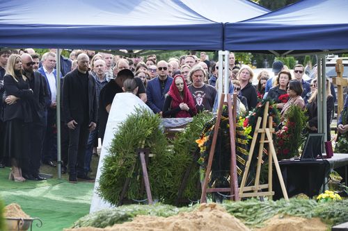 People react by the coffin of the Wagner Group's logistics chief Valery Chekalov, killed in the plane crash, during a funeral at the Severnoye cemetery in St. Petersburg, Russia, Tuesday, Aug. 29, 2023.  