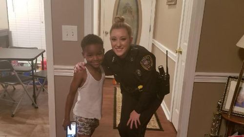 Police officer Lauren Develle turned up at TyLon's door to reassure him Christmas was safe. (Facebook/TeDera Dwayne Graves II)