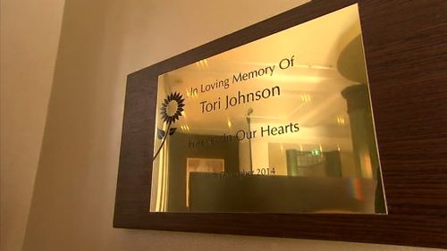 The plaque for Tori Johnson inside the cafe. (9NEWS)