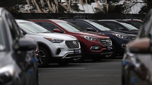 Brand new Hyundai Santa Fe SUVs are displayed at a Hyundai dealership