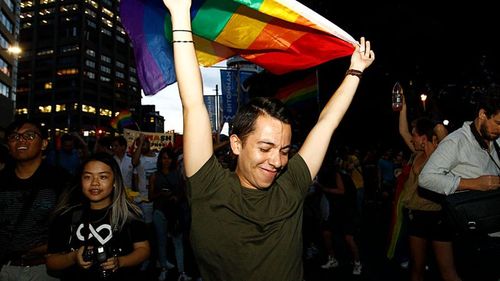 Supporters of same-sex marriage are seen celebrating the victory of the 'Yes' vote in the marriage equality survey at a street party. (AAP)