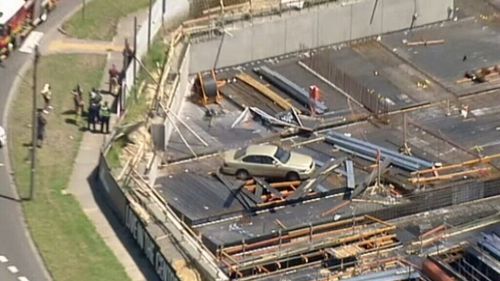 Car perched on scaffolding after crashing into construction site in Burwood East, Melbourne