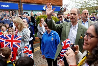 Prince Edward, Duke of Edinburgh waves as he and Sophie, Duchess of Edinburgh arrive to attend a Big Lunch with residents and representatives from the Royal British Legion, the Scouts and the Guides, in Cranleigh Village Hall, Cranleigh village on May 7, 2023 in Cranleigh, England.