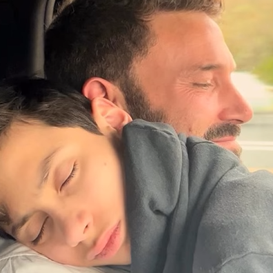 Ben Affleck cuddles Jennifer Lopez's son Max during Thanksgiving celebrations.