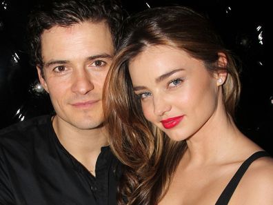 Miranda Kerr smiling during a public appearance, showcasing her poised and elegant style as a supermodel and mother.