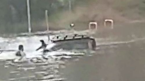 NSW Police rescue man from ute stuck in floodwaters.