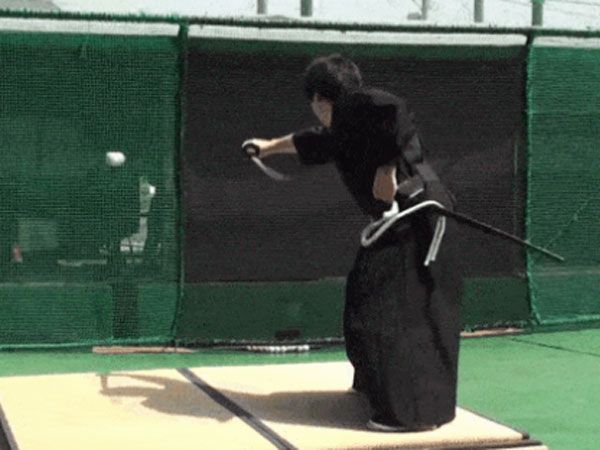Japanaese swod master Isao Machii slices a baseball in half at 160kmh. (Supplied)