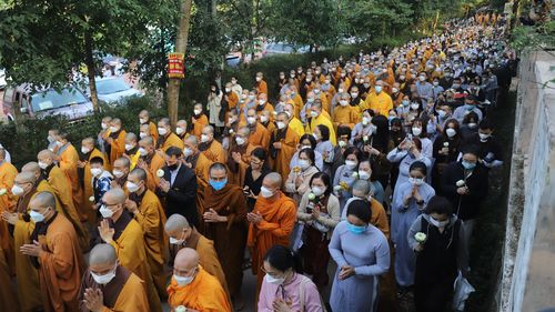 Monks and Thich Nhat Hanh followers trail behind the coffin of the renowned monk during his funeral in Hue, Vietnam on Saturday, Jan. 29, 2022. The Zen Master, who helped spread the practice of mindfulness in the West and socially engaged Buddhism in the East died on Jan. 22, 2022 at the age of 95. (AP Photo/Thanh Vo)