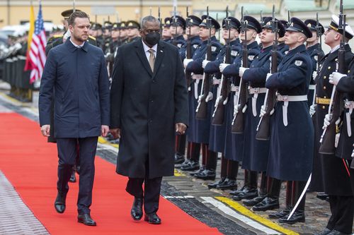 Lithuania's Minister of Foreign Affairs Gabrielius Landsbergis, left, as acting Minister of National Defense and U.S. Secretary for Defense Lloyd J. Austin III, review the honor guard on the occasion of a welcome ceremony at the Defense Ministry in Vilnius, Lithuania, Saturday, Feb. 19, 2022.  