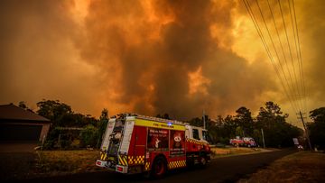 A bushfire approaches homes on the outskirts of the town of Bargo on December 21, 2019.