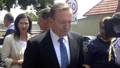 Prime Minister Tony Abbott fields questions outside St Marks Coptic Orthodox Church in Sydney yesterday. (AAP)