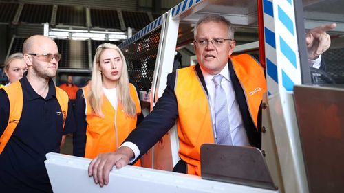 Prime Minister Scott Morrison in his second high-vis vest of the day on Monday.