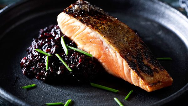 Janet DeNeefe's black rice risotto and salmon (Image: Mark Roper)