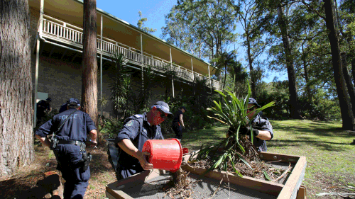 Officers are sifting through the garden by hand at the Kendall property.