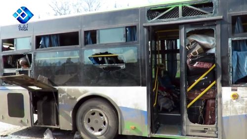 A damaged bus at the scene of the car bomb attack west of Aleppo. (AAP)