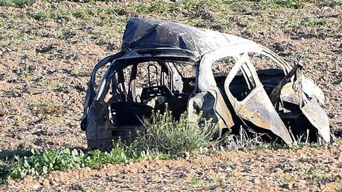 The wreckage of the car of investigative journalist Daphne Caruana Galizia lies next to a road in the town of Mosta, Malta.