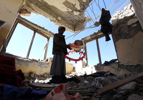 A man inspects a house of 11-members from one family after it was allegedly hit by airstrikes carried out by the Saudi-led coalition in December, 2017. (Getty)