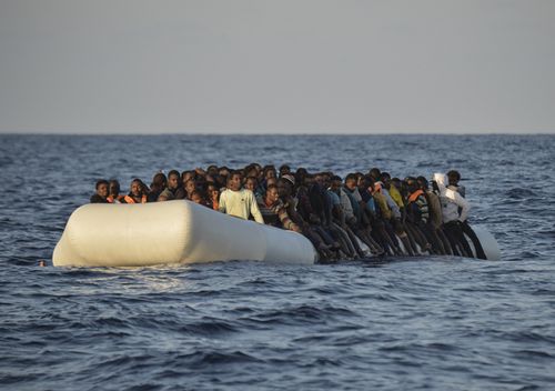 migrants and refugees on a rubber boat before to be rescued by the ship Topaz Responder run by Maltese NGO Moas and Italian Red Cross off the Libyan coast in the Mediterranean Sea, on November 3, 2016
