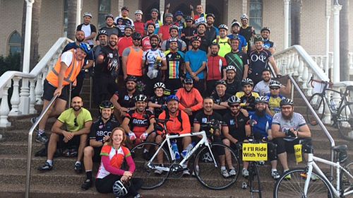 Cyclists pose outside the Lakemba Mosque ahead of today's ride.