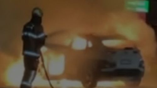 Police are still unsure how a car burst into flames at an intersection in Melbourne's north overnight, leaving a man fighting for his life.He managed to run to a nearby house after his passengers dragged him from the car, but was taken to hospital in a critical condition, after the fire broke out about 11.20pm yesterday.