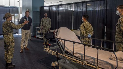 Acting Secretary of the Navy Thomas Modly is toured through the patient transfer process at the Military Sealift Command hospital ship USNS Mercy.