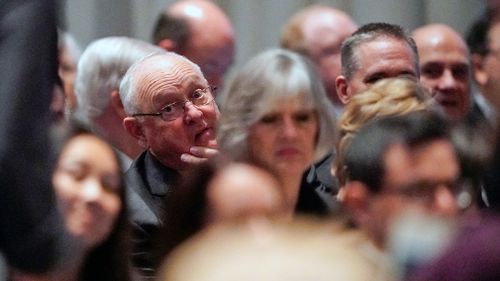 Former Baseball player Nolan Ryan looks back as he arrives for the service.