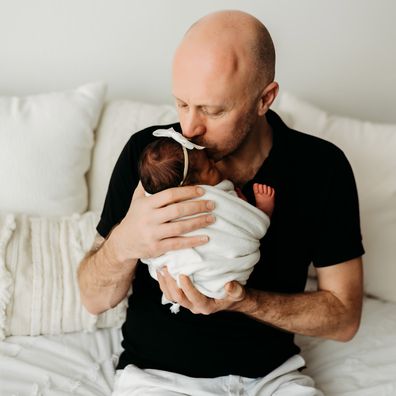 Mark Bowness cuddles up with newborn daughter Mahalia.