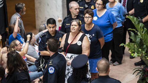 Protesters opposed to President Donald Trump's Supreme Court nominee, Brett Kavanaugh are arrested outside the office of Judiciary Committee Chairman Chuck Grassley, in Washington last week. (AP)