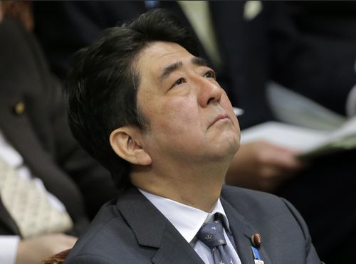 Then Japanese Prime Minister Shinzo Abe listens to a question during a budget committee meeting at Parliament in Tokyo, Tuesday, Feb. 26, 2013