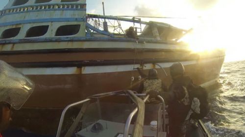 Sailors boarding the vessel with drugs hidden on board. (Supplied)