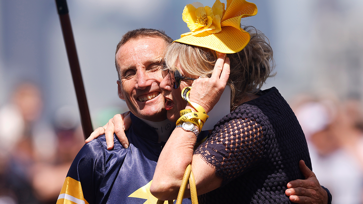 Damien Oliver is hugged by a representative of Alenquer before Race 7, the Lexus Melbourne Cup, during Melbourne Cup Day at Flemington Racecourse.