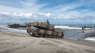 An Australian Army M1A1 Abrams Main Battle Tank from the 2nd Cavalry Regiment lands on the beach