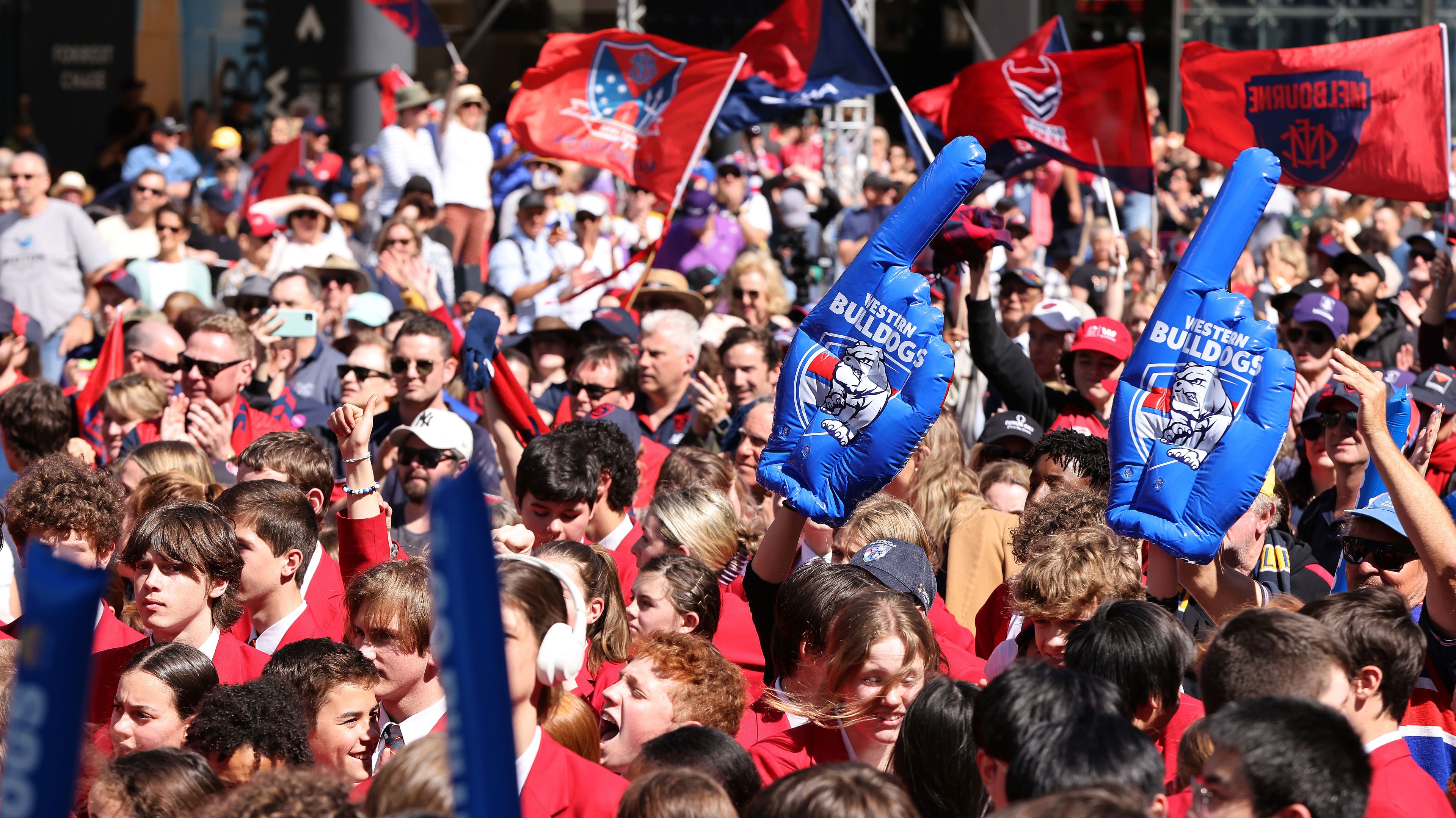 A big crowd gathers for the People&#x27;s Parade ahead of the 2021 AFL Grand Final.