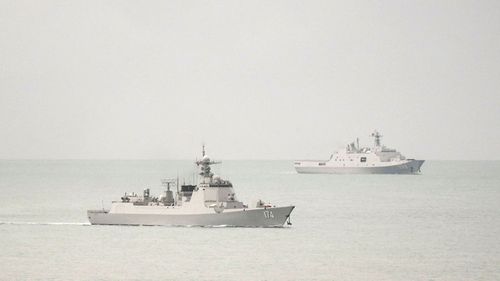 A guided missile destroyer was one of two PLA ships being followed by an RAAF plane