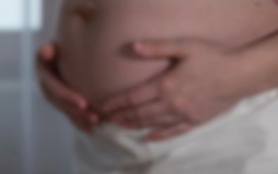 Woman holding her pregnant belly