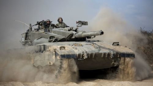 An Israeli tank moves into position on the Gaza border. (AAP)