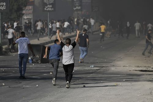 Palestinian demonstrators clash with Israeli forces following a demonstration in support of the Gaza Strip in the West Bank city of Nablus, Friday, Oct. 13, 2023. 