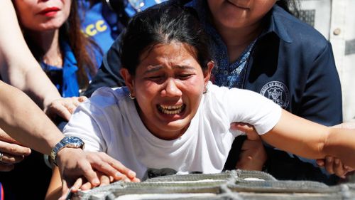 Filipino Jessica Demafelis grieves on the return of her sisters', Joanna Demafelis, remains at Manila's international airport, Philippines. (AAP)