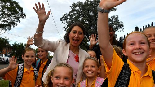 New South Wales Premier Gladys Berejiklian (centre) interacts with students during a visit to Revesby South Public School, in Sydney.