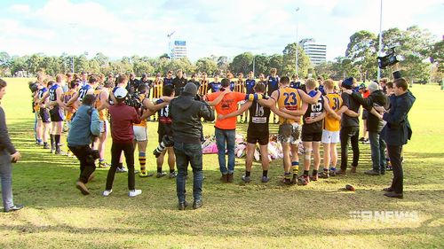 Two opposing football teams stood arm-in-arm observing a minute's silence for the 22-year-old today. Picture: 9NEWS